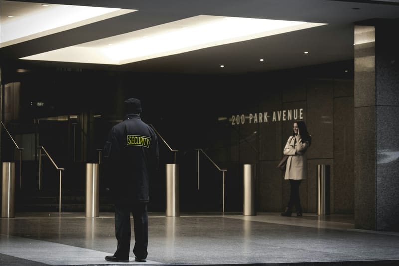 A security officer at the front desk of a corporate lobby