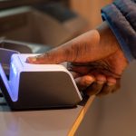 Biometric reader with thumb being scanned